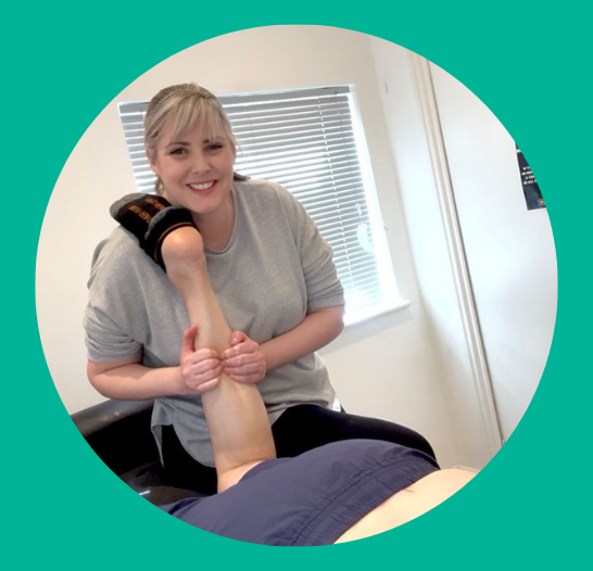 female therapist performing calf massage and smiling