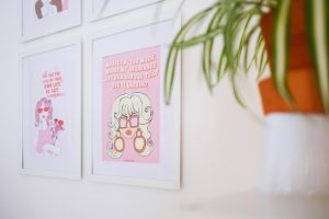 pictures on a wall with a house plant