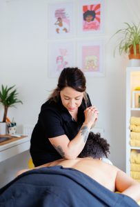 close up of female therapist massaging clients back with elbow in a massage room
