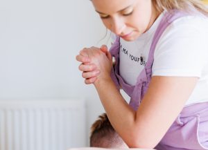 Close up of massage therapist massaging client's back with her elbow in a massage room